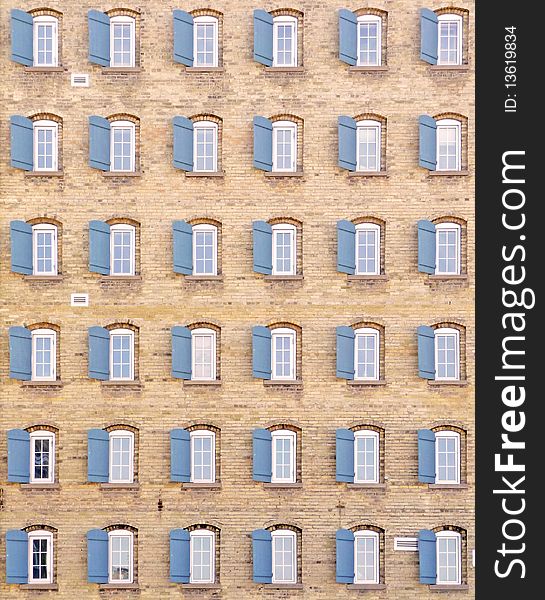 Abstract background image of thirty-six shuttered windows on a vintage building exterior. Abstract background image of thirty-six shuttered windows on a vintage building exterior.