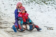 Children Enjoy Snowshoeing In The Snow Park Where The Grass Comes Out Stock Images