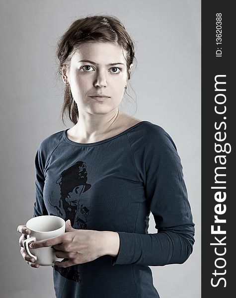 Portrait of young woman holding a cup of tea