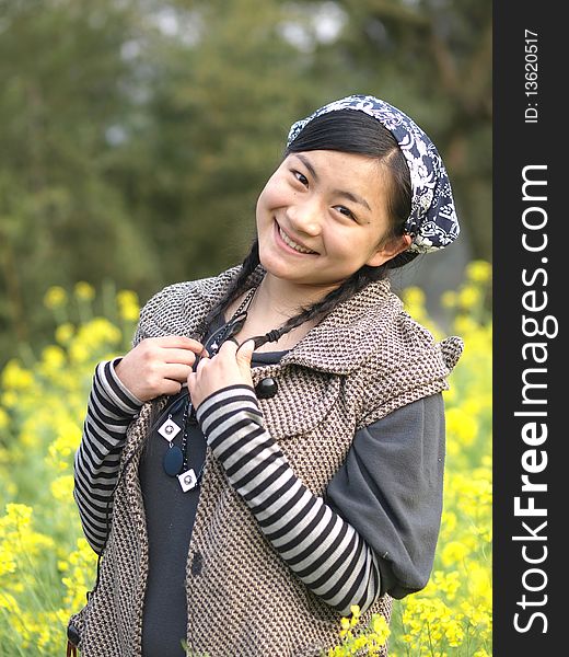 and beautiful young happy woman. In the yellow flower background. and beautiful young happy woman. In the yellow flower background