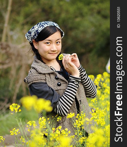 Beautiful young woman holding flower in the garden