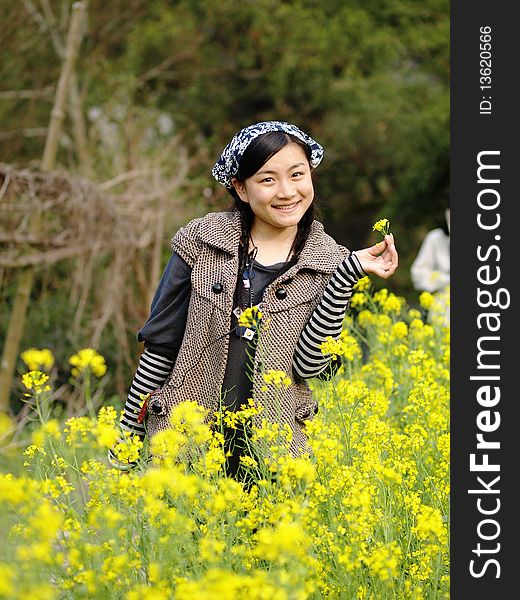 Beautiful young woman holding flower in the garden