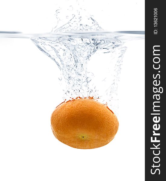 Fresh Tangerine splashing into water with white background