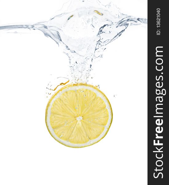 Lemon slice splashing into water with white background