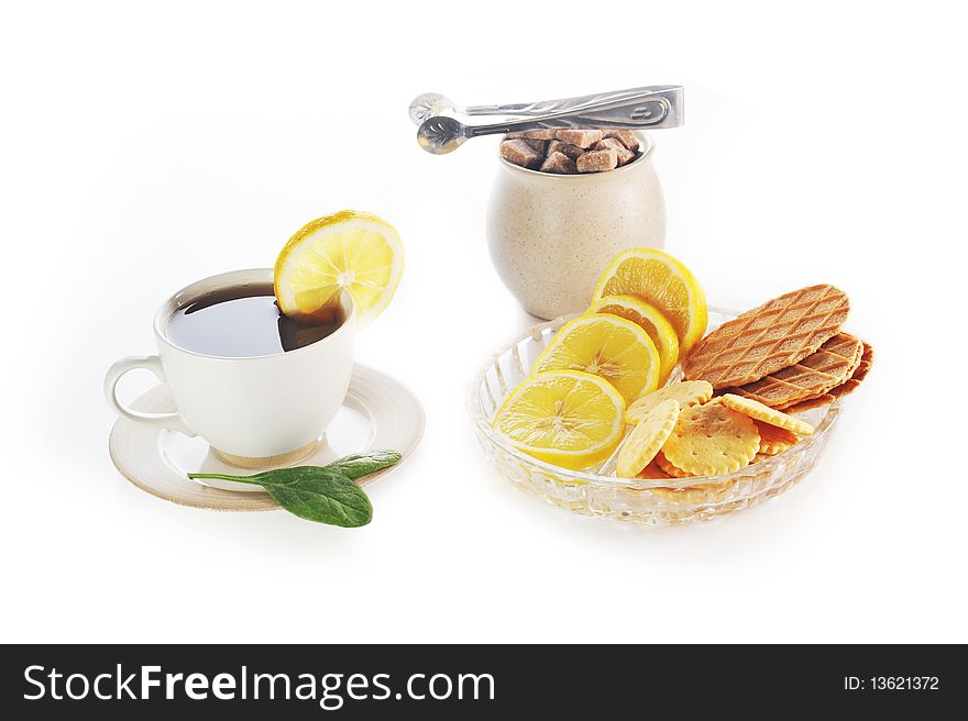 Cup of tea with lemon, pastry  and sugar