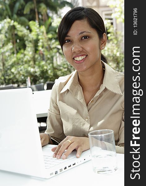 An Asian businesswoman working with her laptop