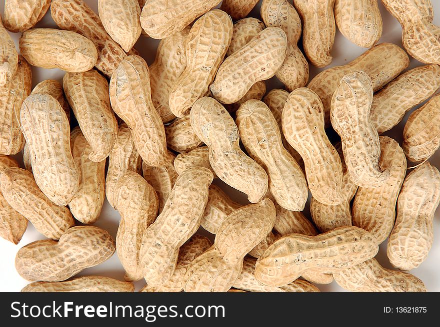 Pile of raw peanuts in shells as a background