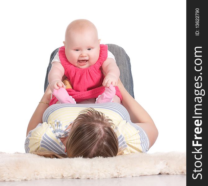 Happy young mother playing with her baby. Isolated on a white background