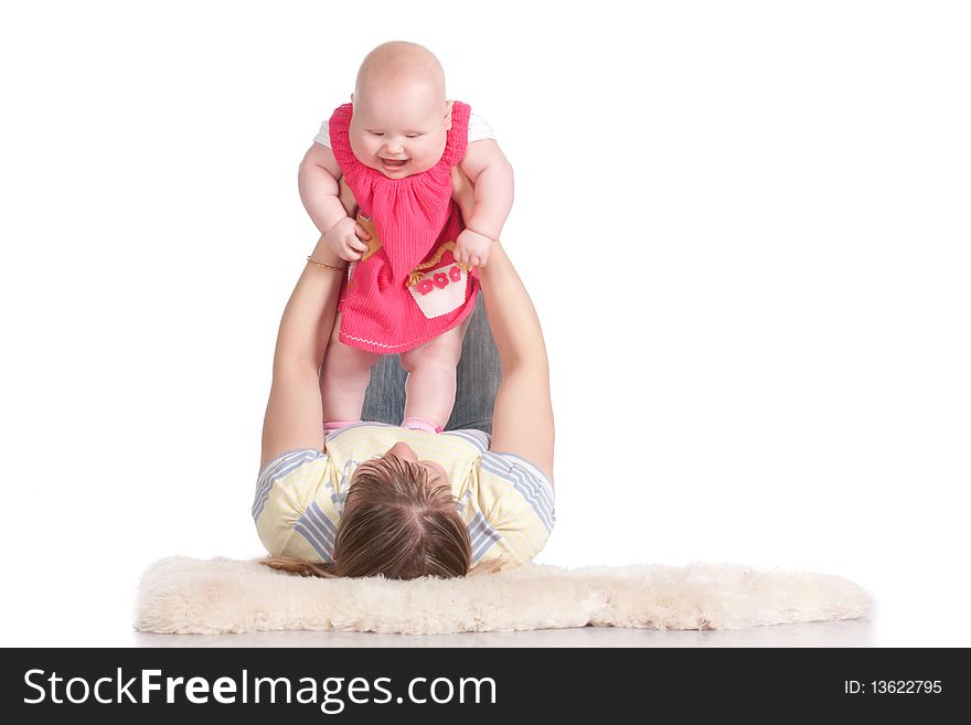 Happy young mother playing with her baby. Isolated on a white background
