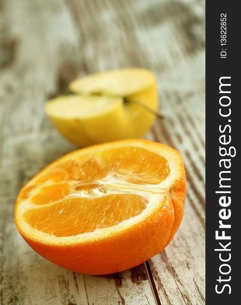 part of orange and apple on wooden background