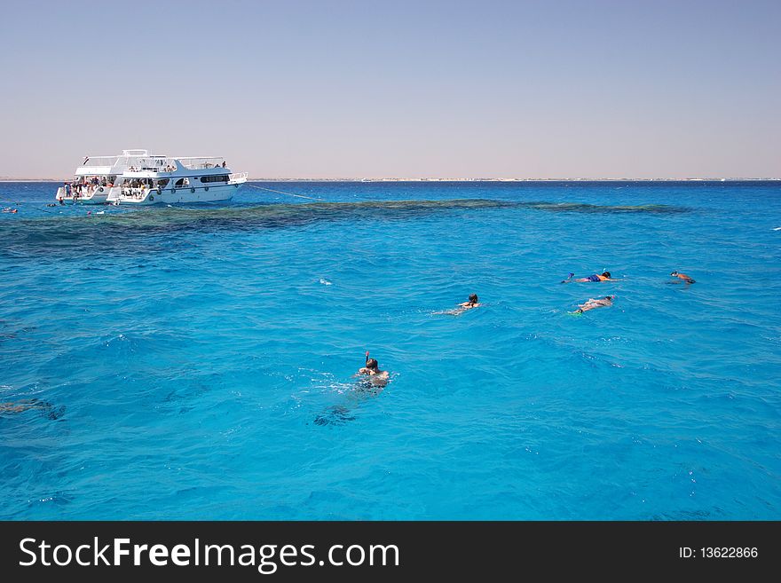 Picture of Boats and snorkeling people on a coral reef, Red Sea, Egypt.