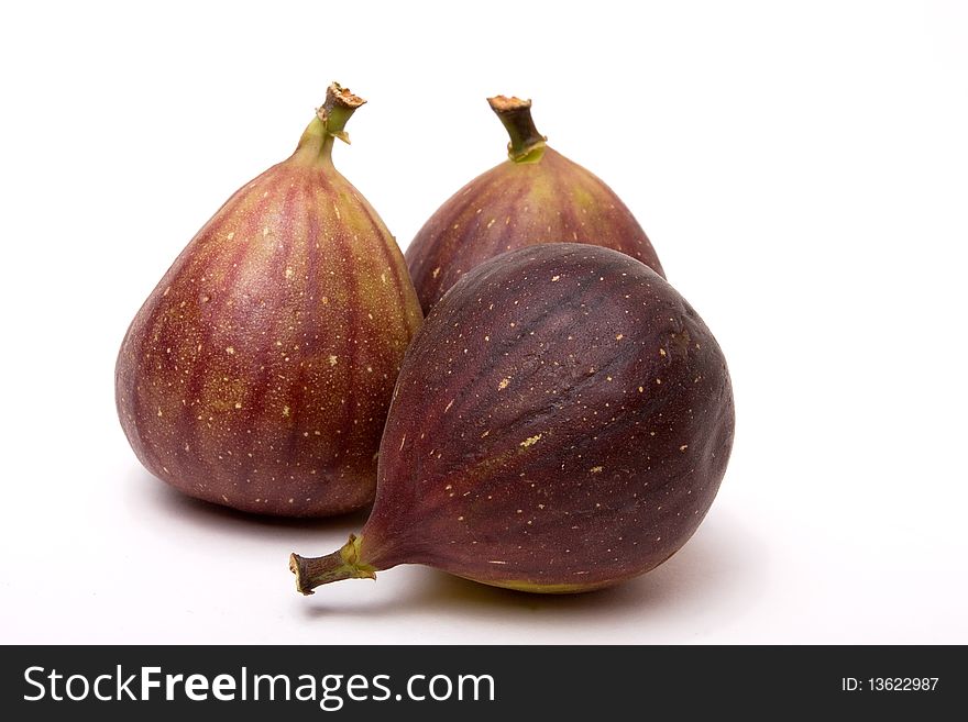 Three ripe figs isolated against white background.