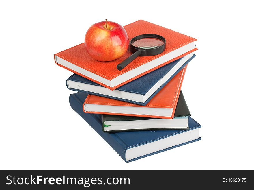 Ripe Apple And Magnifying Glass On Stack Of Books