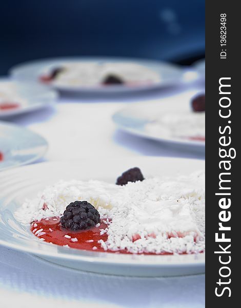 Delicious display of dewberry desert with ice-cream and coconut flakes. Delicious display of dewberry desert with ice-cream and coconut flakes
