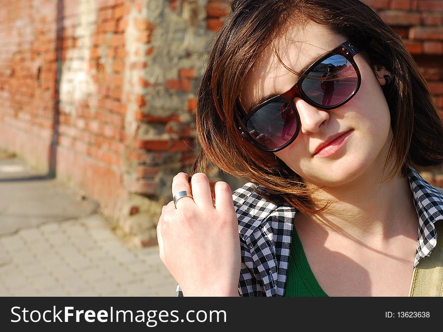 Portrait of a beautiful young woman wearing sunglasses. Portrait of a beautiful young woman wearing sunglasses