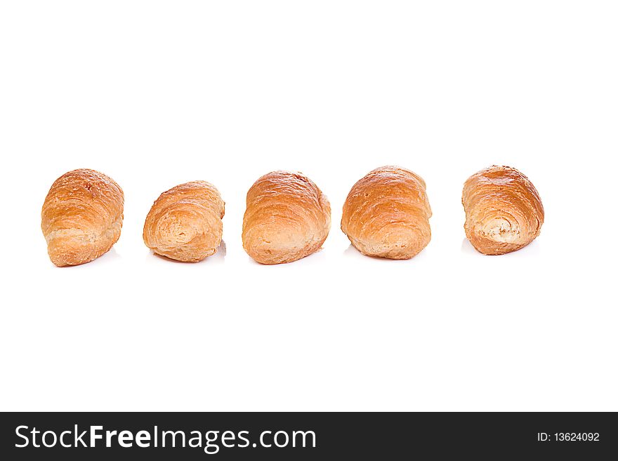 Five isolated croissants on white