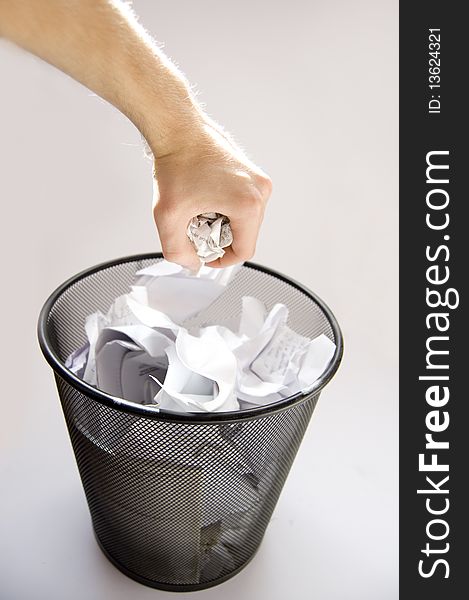 Garbage conceptual image. Man throws paper into a full garbage.