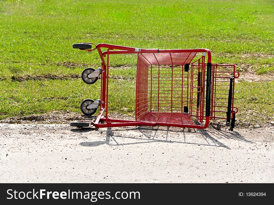 An overturned and abandoned grocery cart. An overturned and abandoned grocery cart.