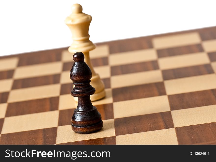 Chess pieces on a chessboard against a white background
