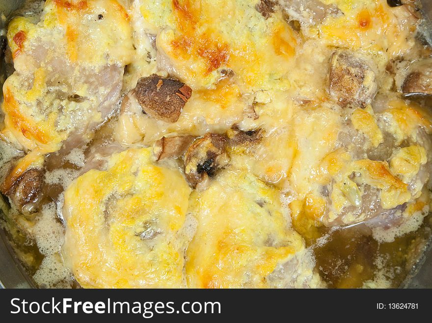 Closeup of  stewed chicken with mushrooms and cheese