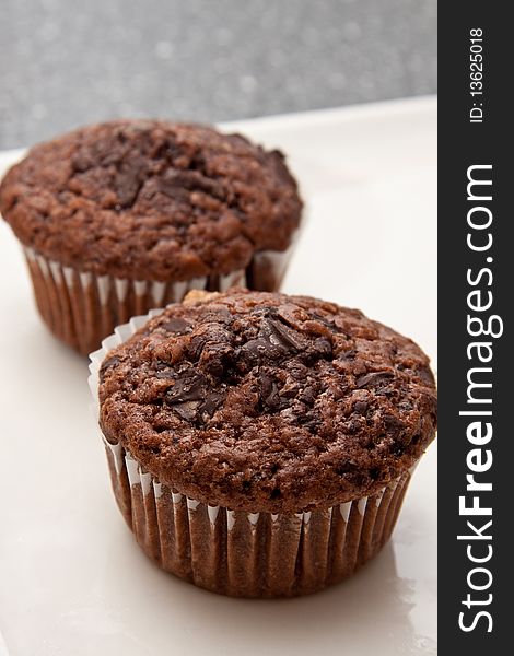 Delicious fresh chocolate muffins standing on a table