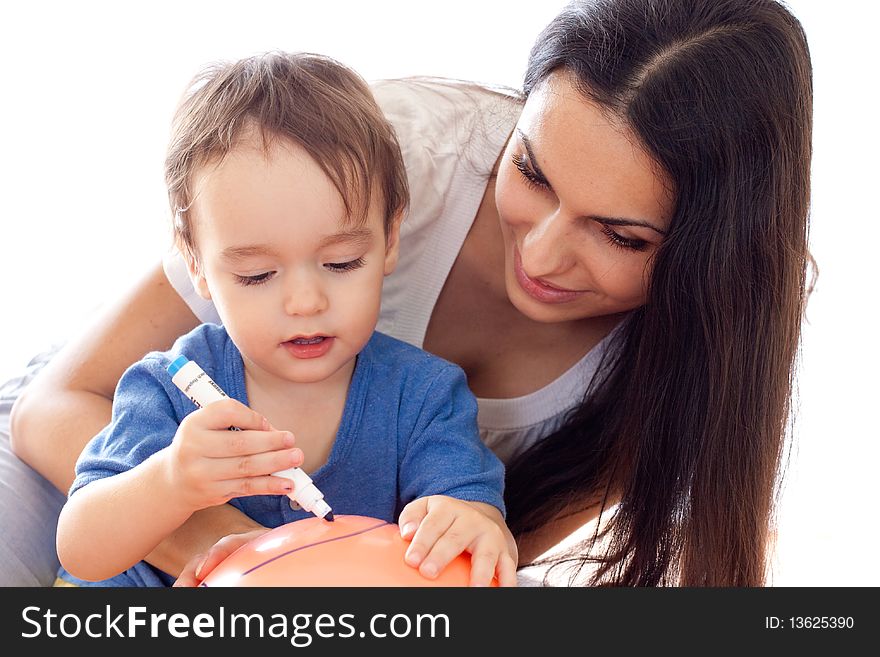 Mother and son drawing picture on red balloon together. Mother and son drawing picture on red balloon together