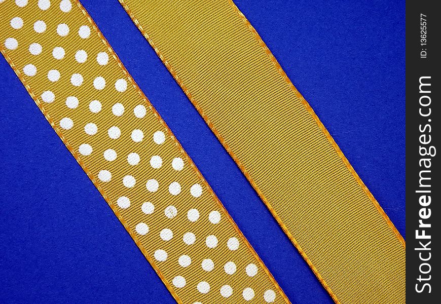 Dotted yellow ribon isolated on blue. Dotted yellow ribon isolated on blue