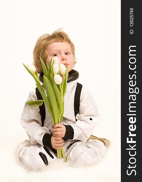 Astronaut boy holding a bouquet of white tulips