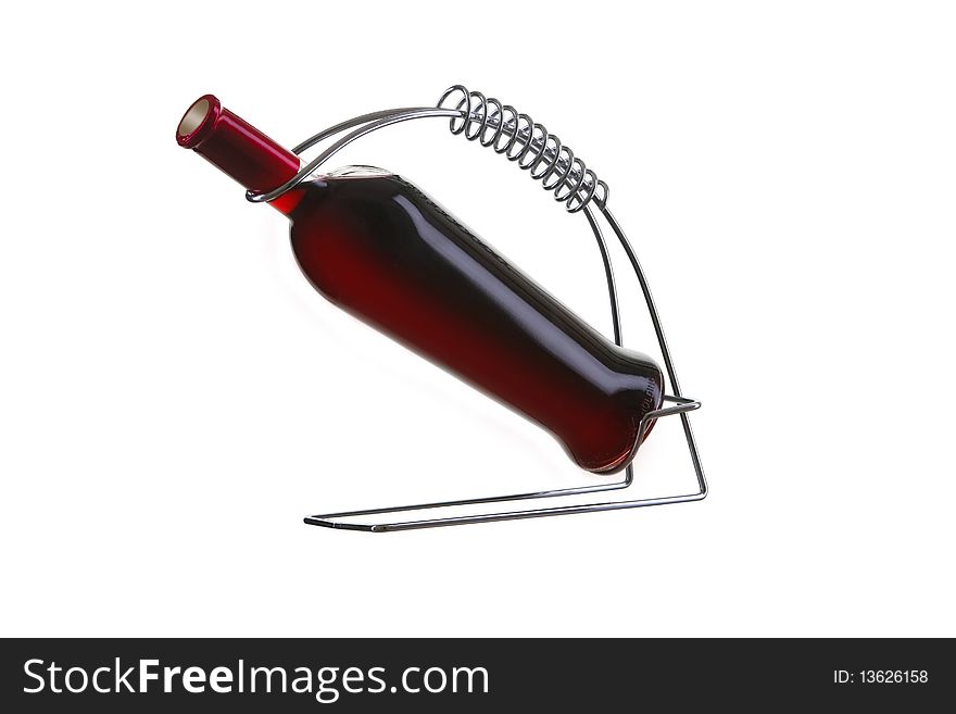Bottle of wine in holder on white isolated
