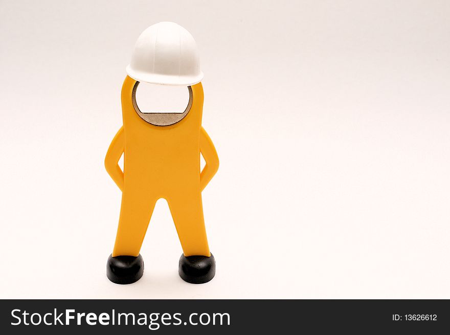 Close-up picture of a figure of a worker with white helmet. Close-up picture of a figure of a worker with white helmet