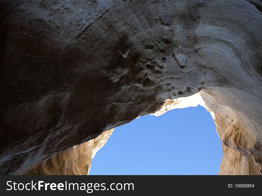 Hole with blue sky in the rock wall. Hole with blue sky in the rock wall