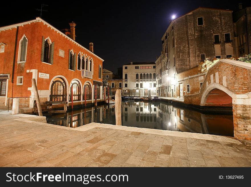 Venetian houses and canal at night in the streets of Venice, Italy. Venetian houses and canal at night in the streets of Venice, Italy
