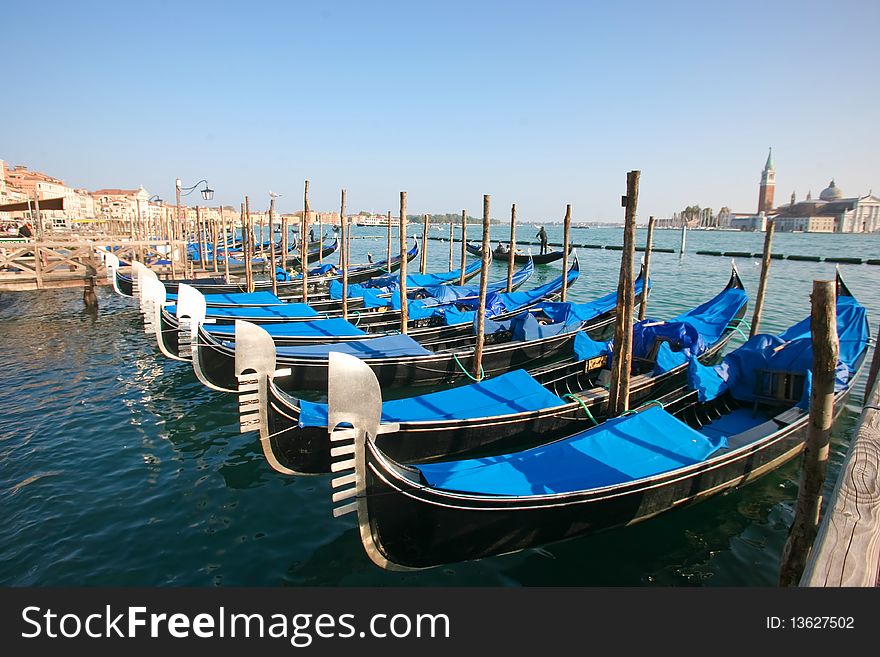 Group of gondolas docked on the water in Venice, Italy. Group of gondolas docked on the water in Venice, Italy