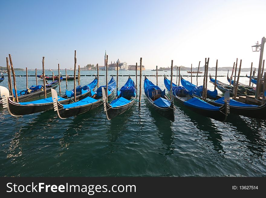 Group of gondolas docked on the water. Group of gondolas docked on the water.