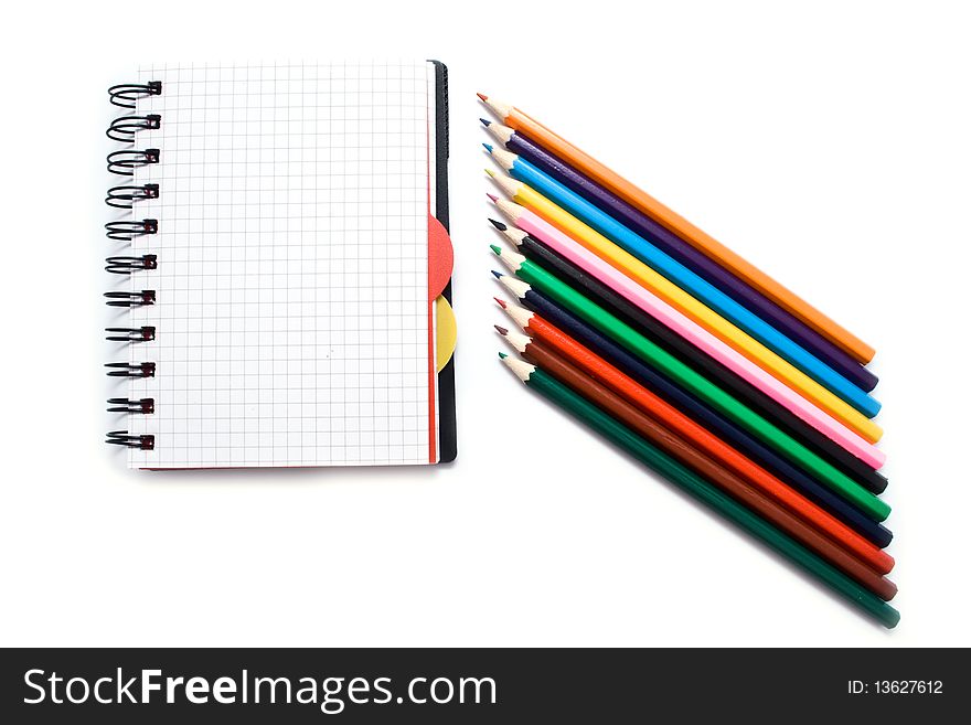 Notebook with a spring and pencils on a white background