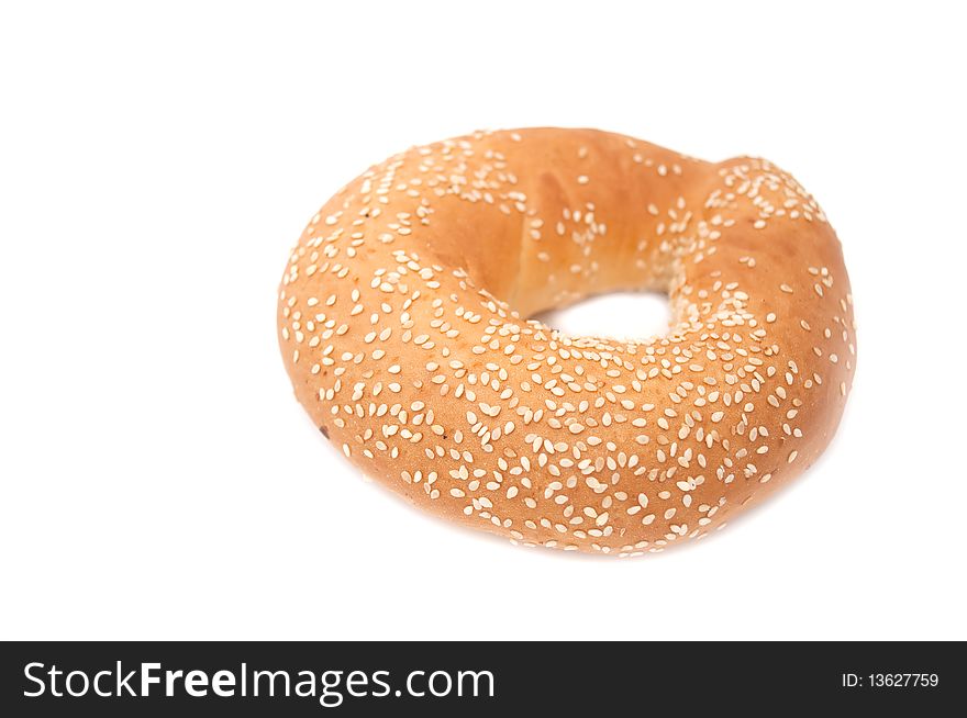 A freshly baked bagel with sesame seeds isolated on a white background