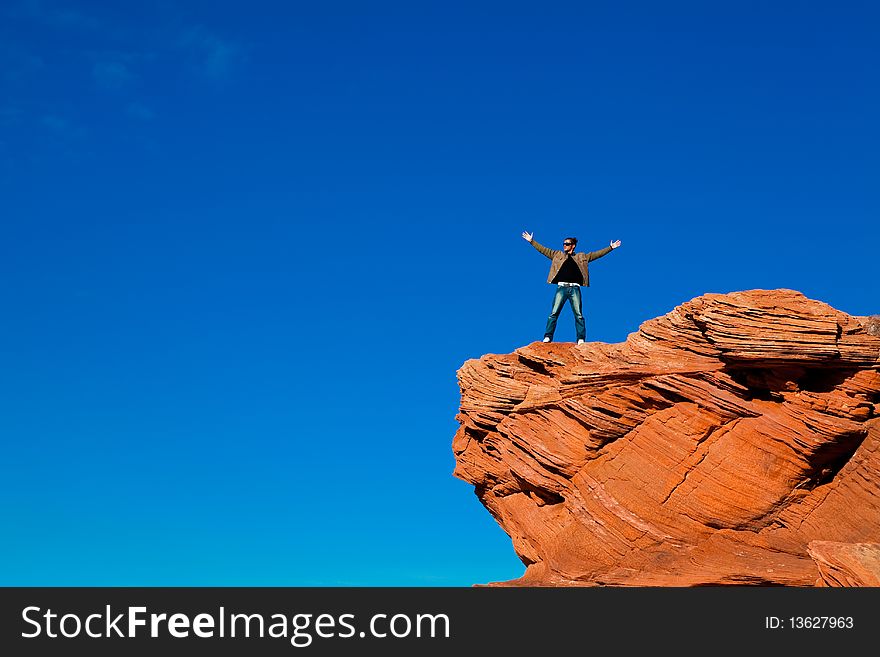 Man standing on the edge of the rock. Man standing on the edge of the rock