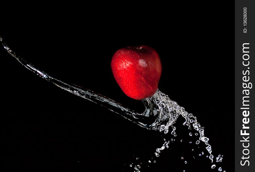 Apple in water on black background