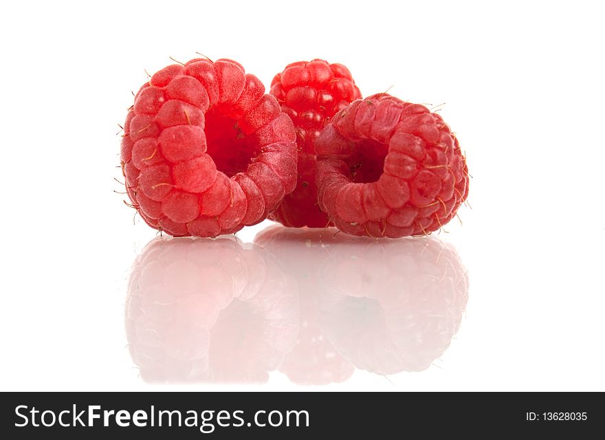 Red raspberry with reflection isolated on white