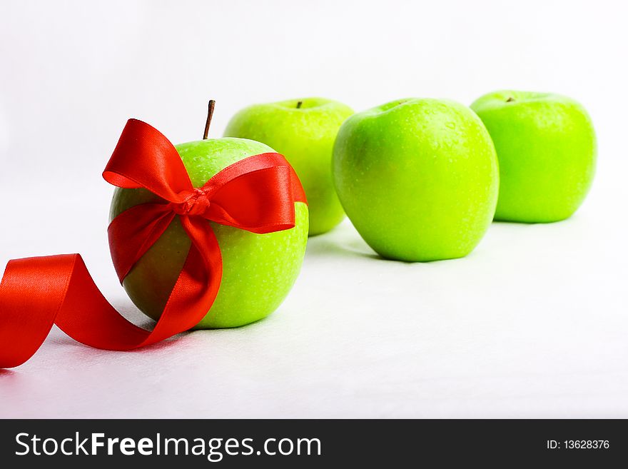 The green apple is decorated red by a tape allocated among others