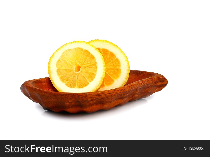 Slices of lemon on a wooden plate. Slices of lemon on a wooden plate
