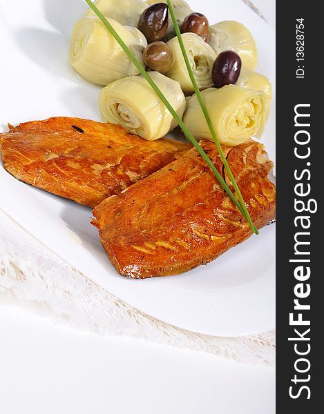 Closeup with fish, onions and olives on white plate. Closeup with fish, onions and olives on white plate