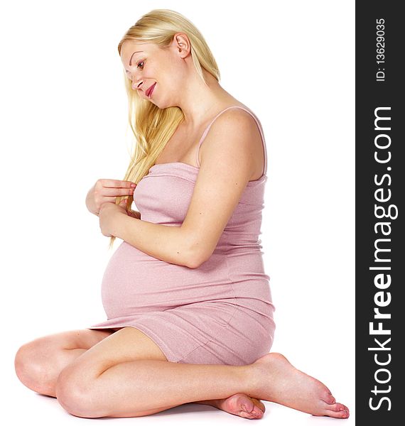 Happy pregnant woman sitting over white