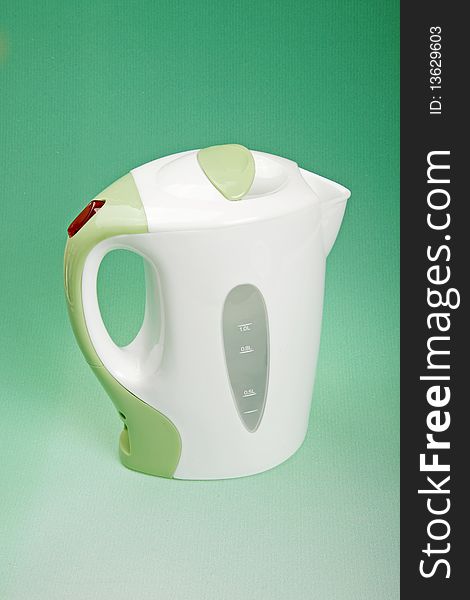 Electric kettle on green background