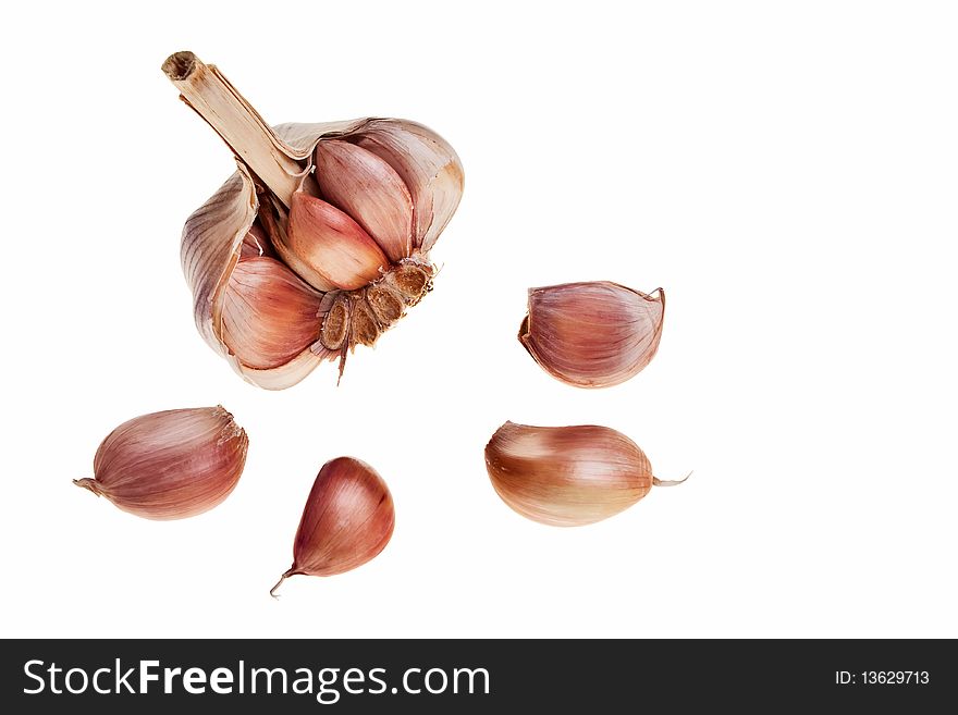Garlic bulb and small pieces isolated over white background. Garlic bulb and small pieces isolated over white background.