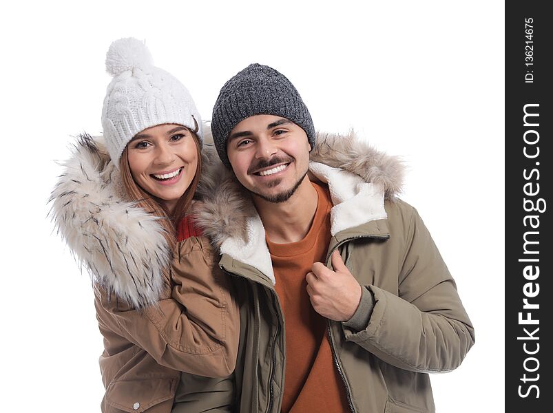 Young couple wearing warm clothes on white background