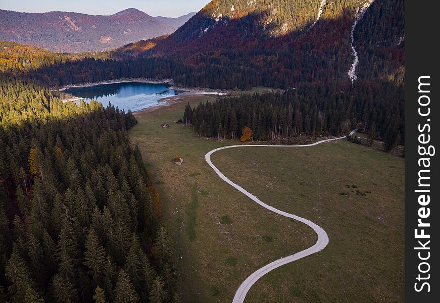 Aerial view over road leading into Fusine Lakes,Italy
