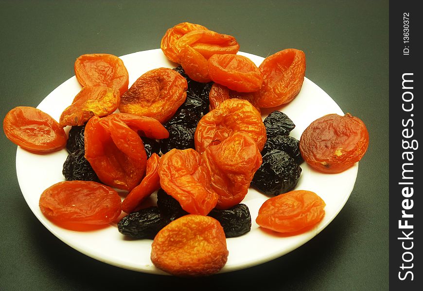 Sweet honey prunes and orange fragrant apricot for fruit salad. Sweet honey prunes and orange fragrant apricot for fruit salad