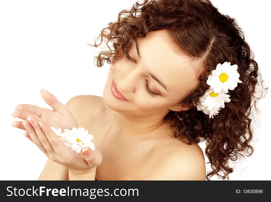 Beautiful woman with camomile flower on white background