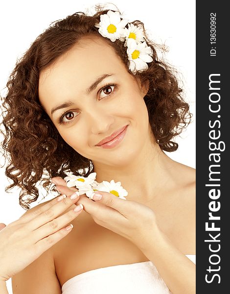 Beautiful woman with camomile flower on white background